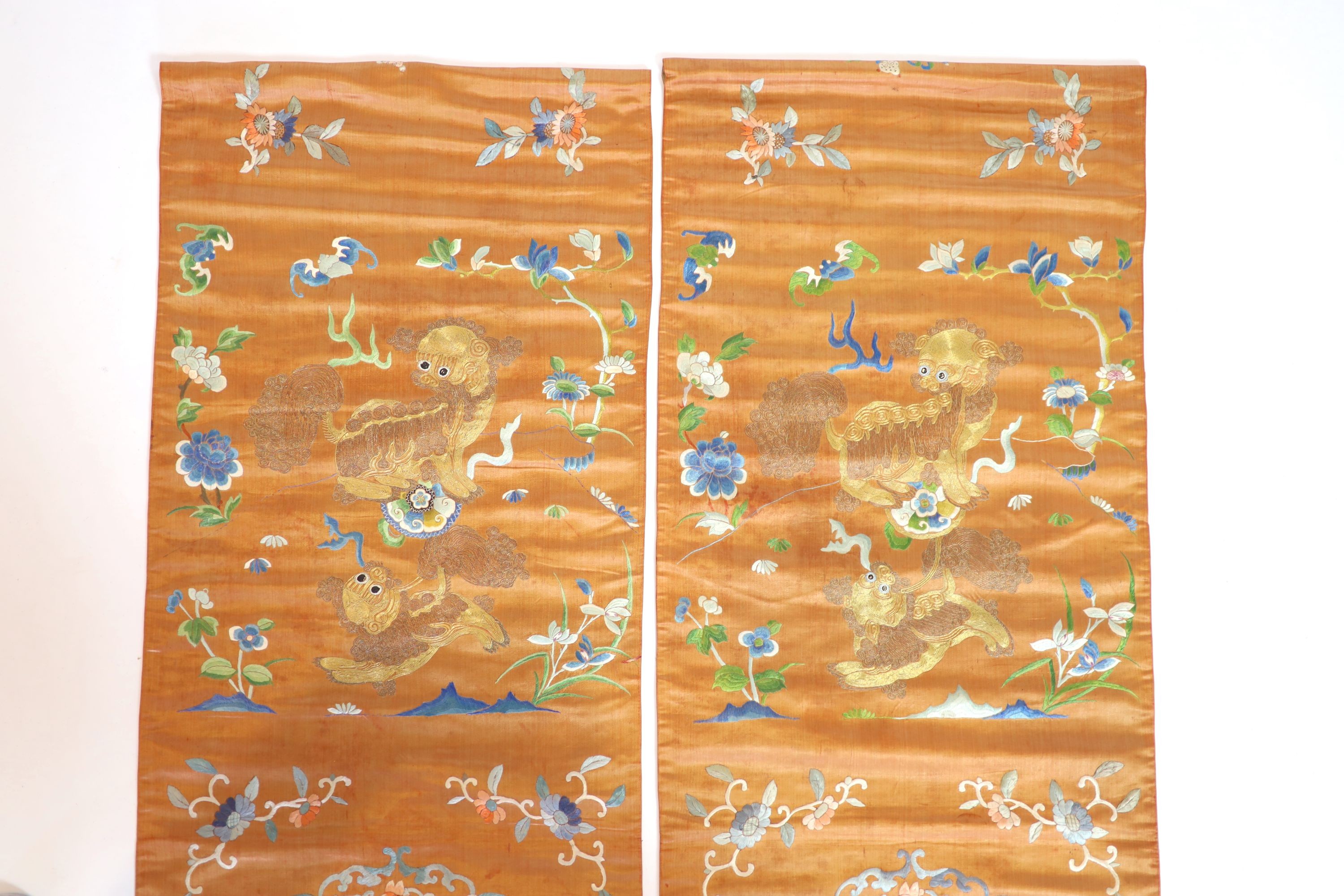 A pair of Chinese peach silk embroidered hangings, 19th century 137 x 44 cm